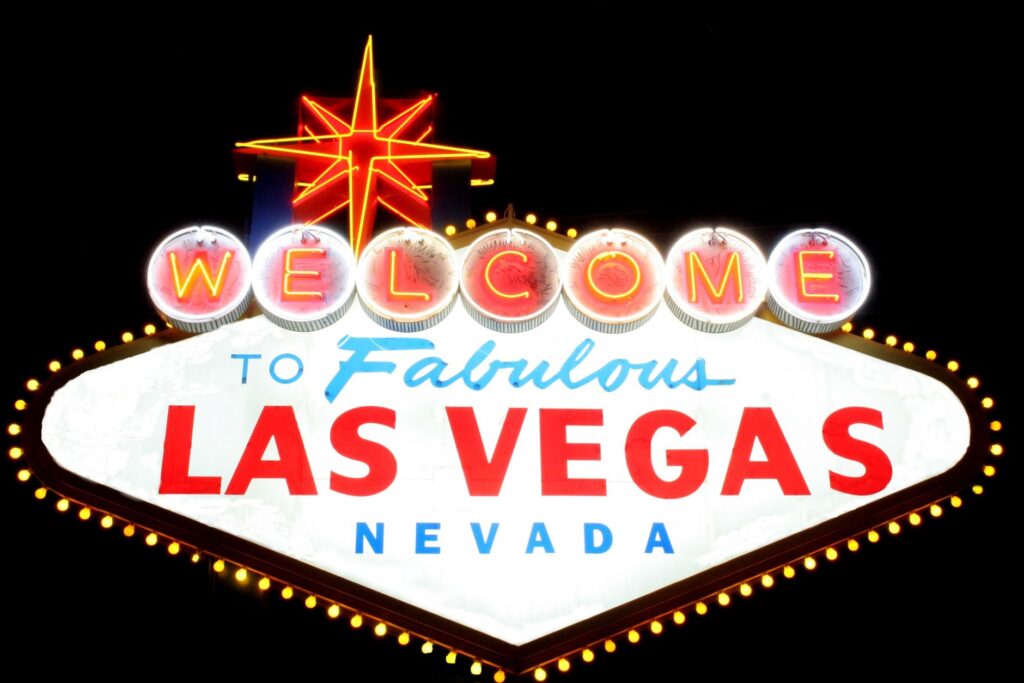 A view of the Las Vegas Strip at night, with bright lights and show advertisements. — best shows in Las Vegas 2026