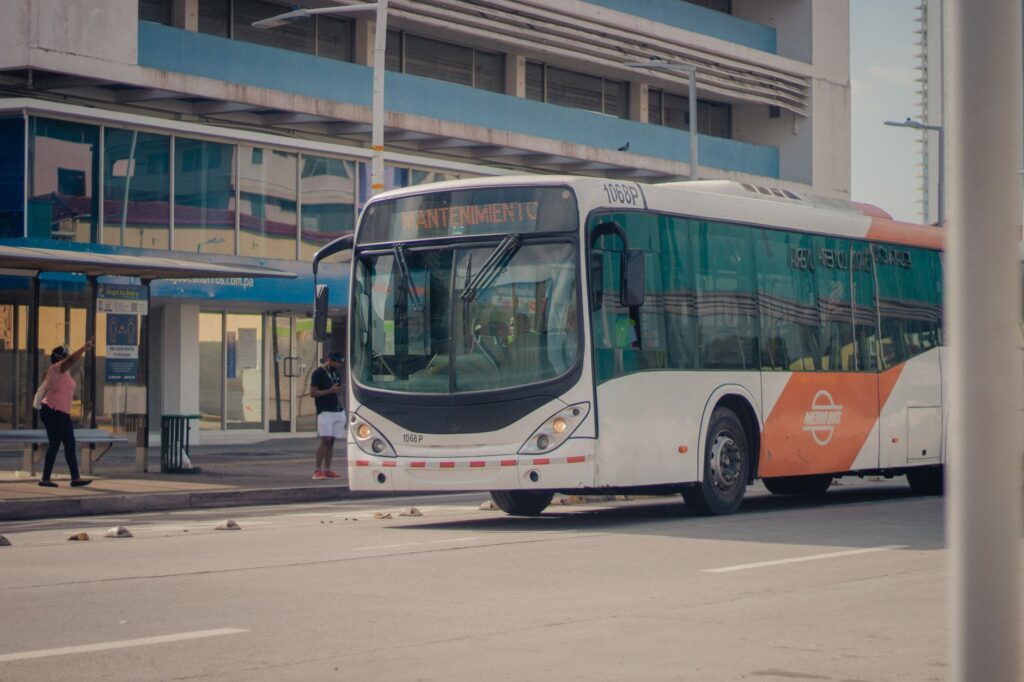 An RTC bus at a bus stop on the Strip with tourists boarding — getting around Las Vegas