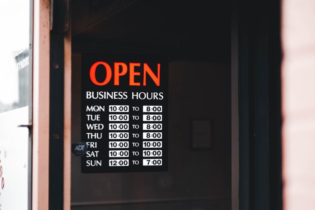 An affordable club entrance with a sign displaying happy hour specials. — Vegas nightlife budget tips