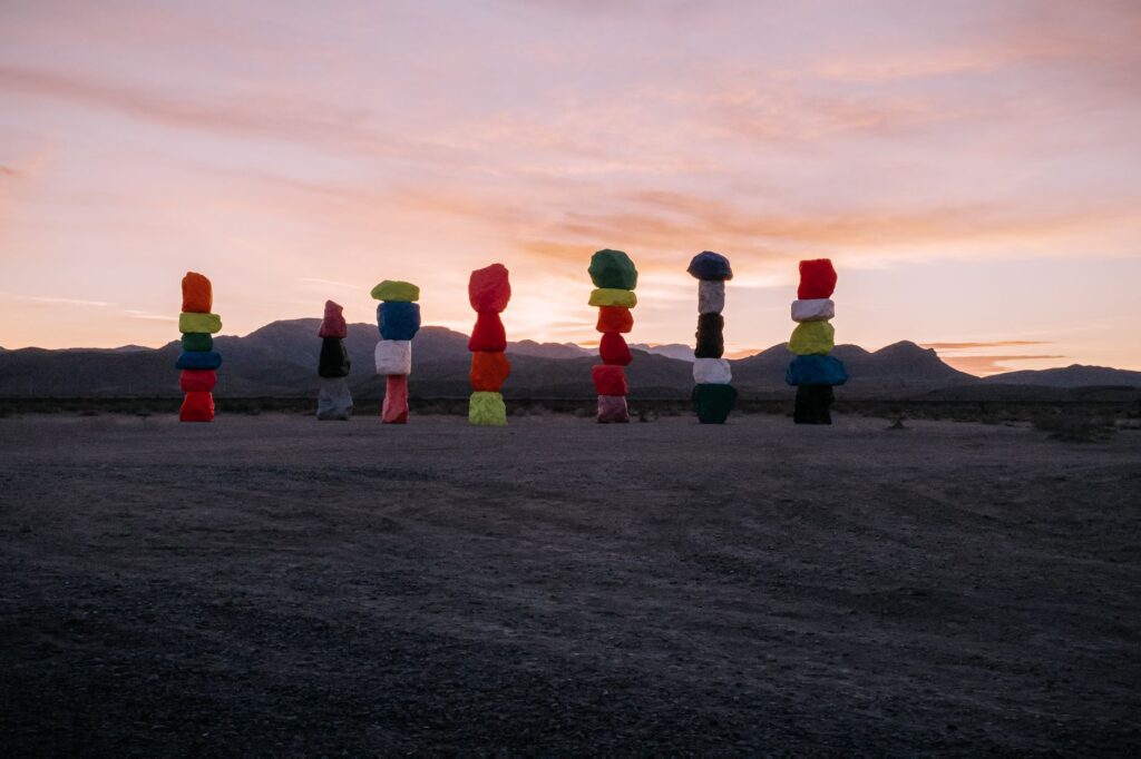 An artistic representation of the Seven Magic Mountains in the desert. — hidden gems in Las Vegas