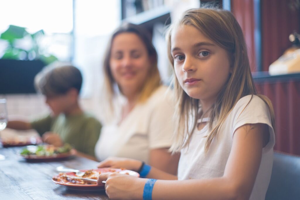 Families enjoying a meal at a kid-friendly restaurant near the Las Vegas Strip. — family shows in Las Vegas
