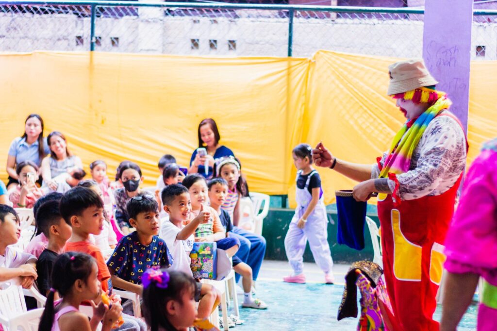 Kids watching a magic show in Las Vegas, captivated by the performer's tricks. — family-friendly activities Las Vegas