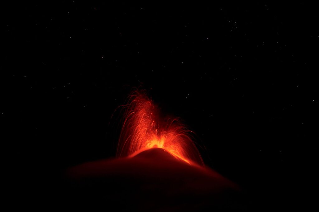 The Mirage Volcano erupting in a fiery display against the night sky — free attractions Las Vegas