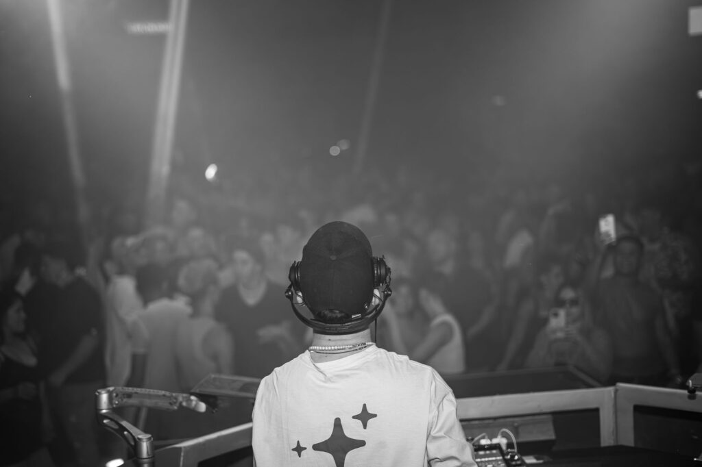 A DJ performing live at one of the best clubs in Vegas 2026, with a crowd dancing energetically. — Las Vegas nightclubs