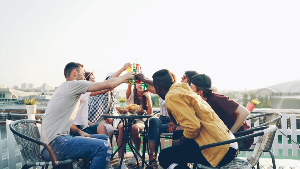 A group of friends enjoying cocktails at a rooftop bar with a stunning view of the Las Vegas Strip. — Las Vegas nightlife