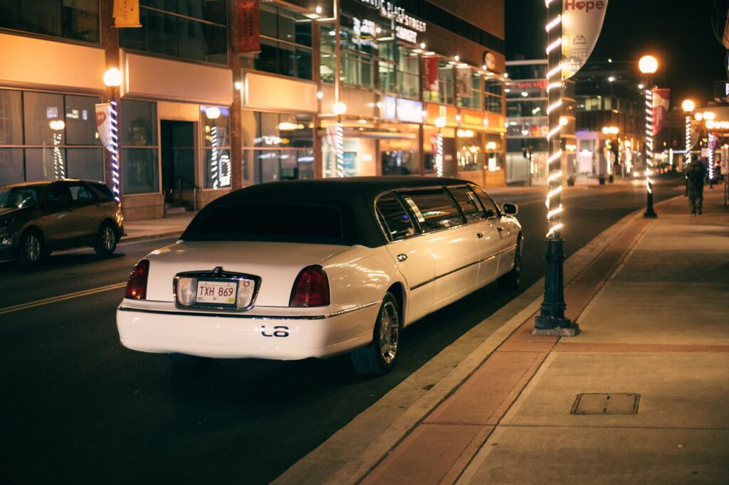 A stylish limousine parked outside a luxurious Las Vegas hotel, representing VIP transportation. — Las Vegas nightlife tips